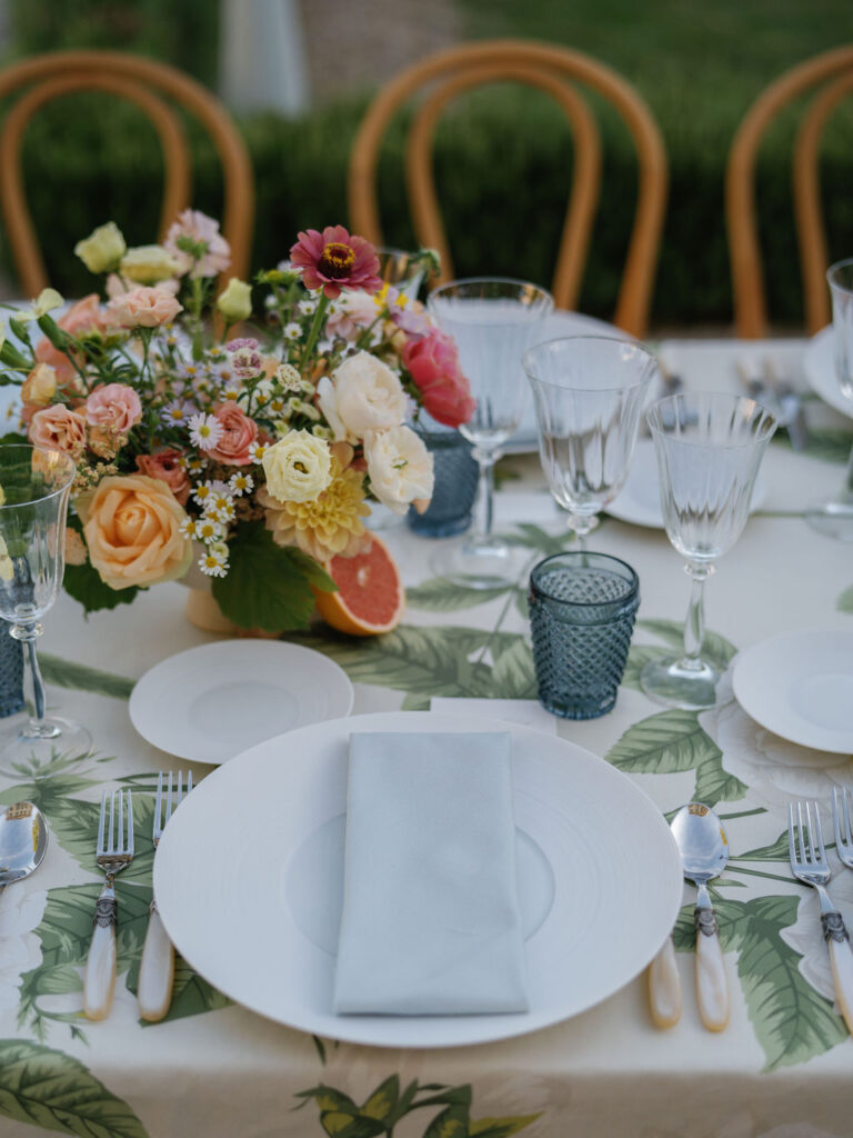 Close-up of a Provence wedding tablescape with floral centerpiece and place settings.