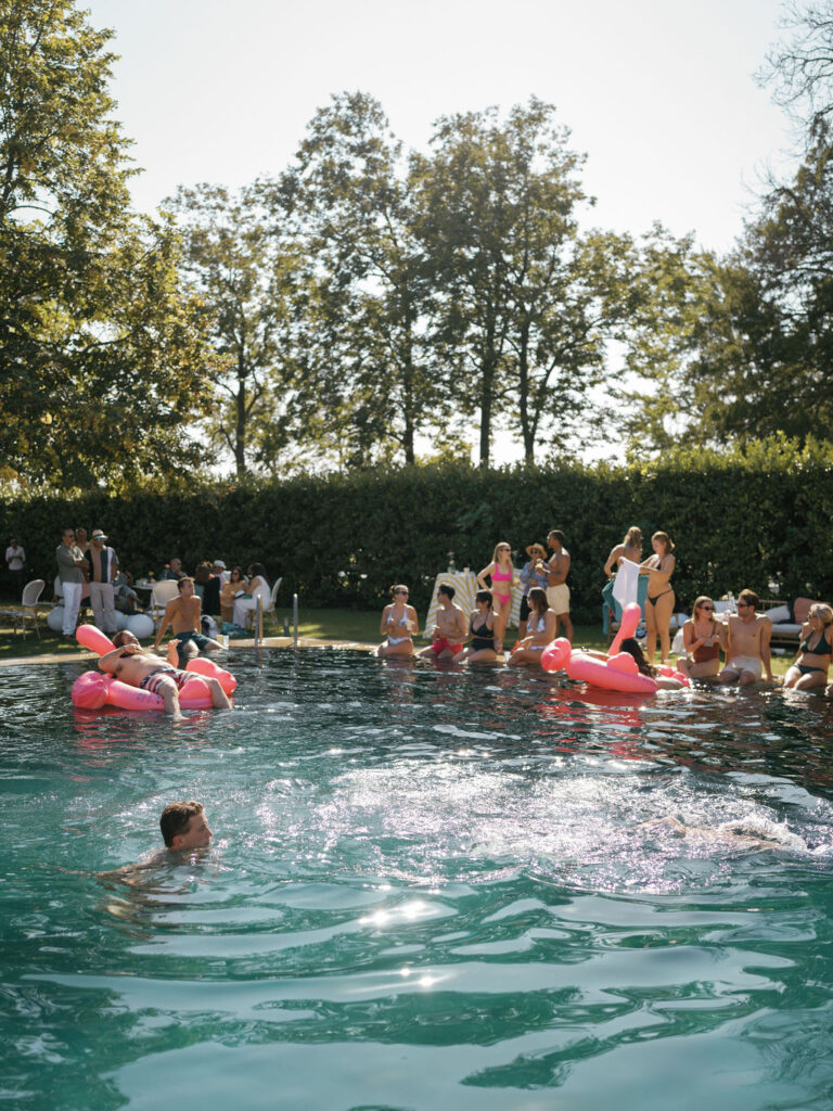 Poolside gathering with guests during a Provence destination wedding planned by a destination wedding planner in France.