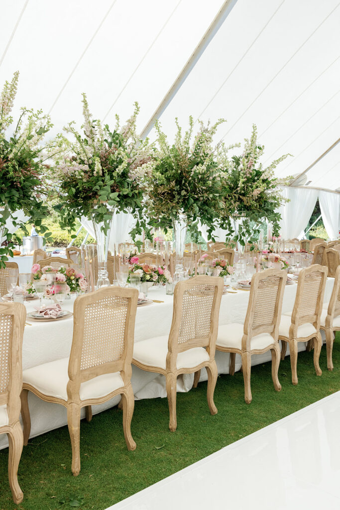 Elegant reception table under a sailcloth tent designed by a Santa Barbara wedding planner