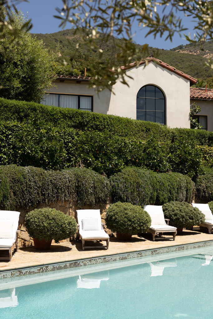 California destination wedding venue with Mediterranean-style villa, hillside views, and poolside lounge seating.