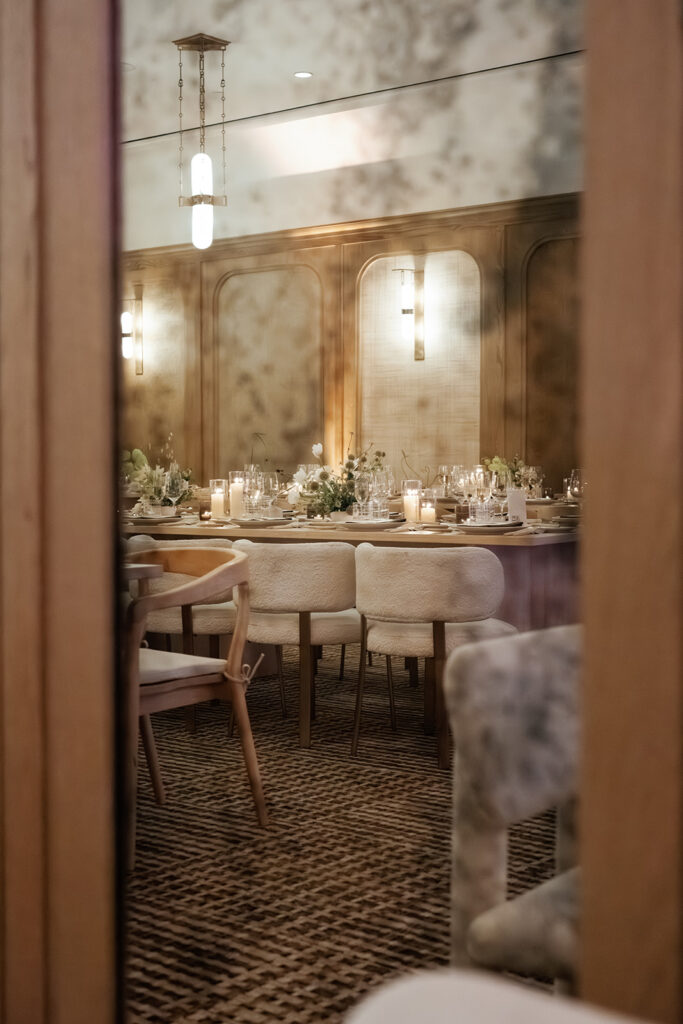 Layered wedding reception design viewed through architectural framing, showcasing thoughtful layout and atmosphere included in full service wedding planning.