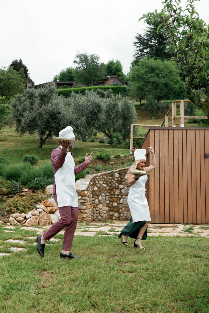 Chefs dancing playfully outdoors during a wedding weekend, adding personality and connection to the guest experience.