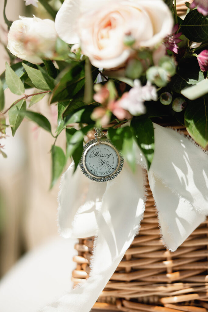 Floral basket detail with personalized wedding favors for guests at an elevated coastal wedding