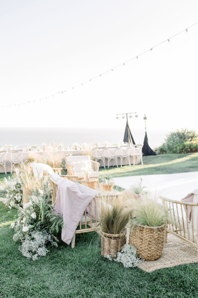 Elegant outdoor wedding reception at a California private estate venue with white linens and coastal views at sunset